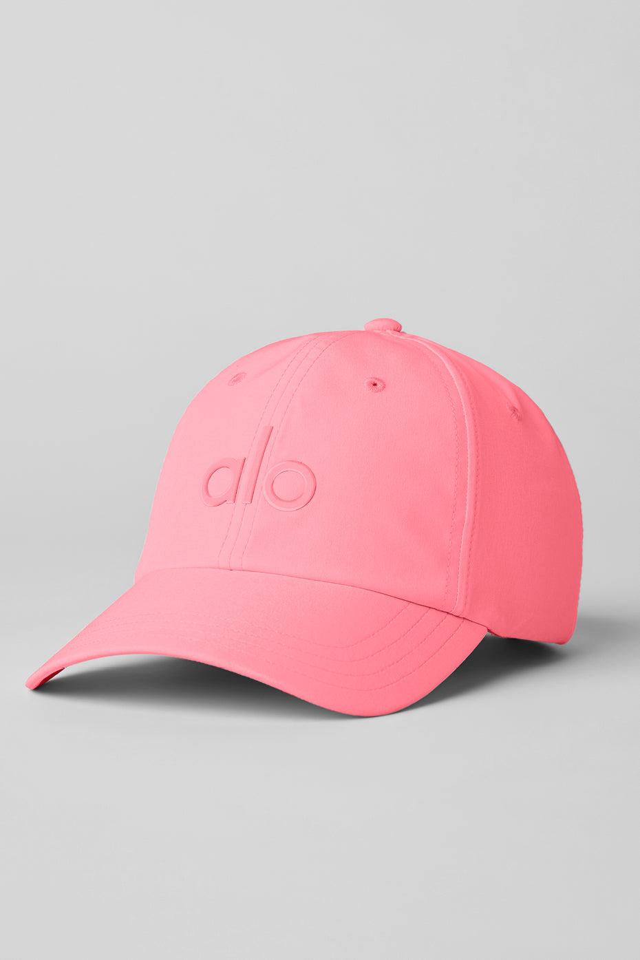 Neon Bubblegum performance cap worn outdoors, showing sweat-wicking fabric.