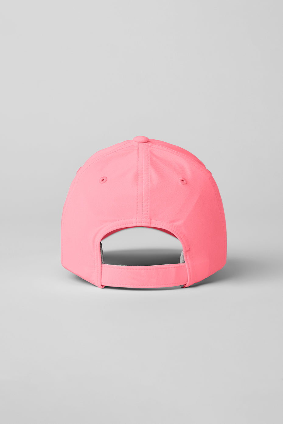 Neon Bubblegum performance cap worn outdoors, showing sweat-wicking fabric.