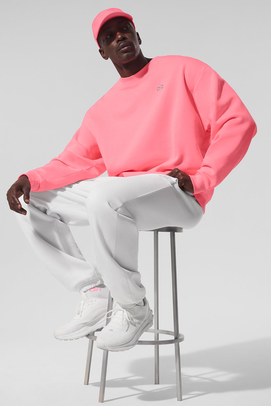 Front view of the Accolade crew neck pullover in neon bubblegum showing the chrome logo
