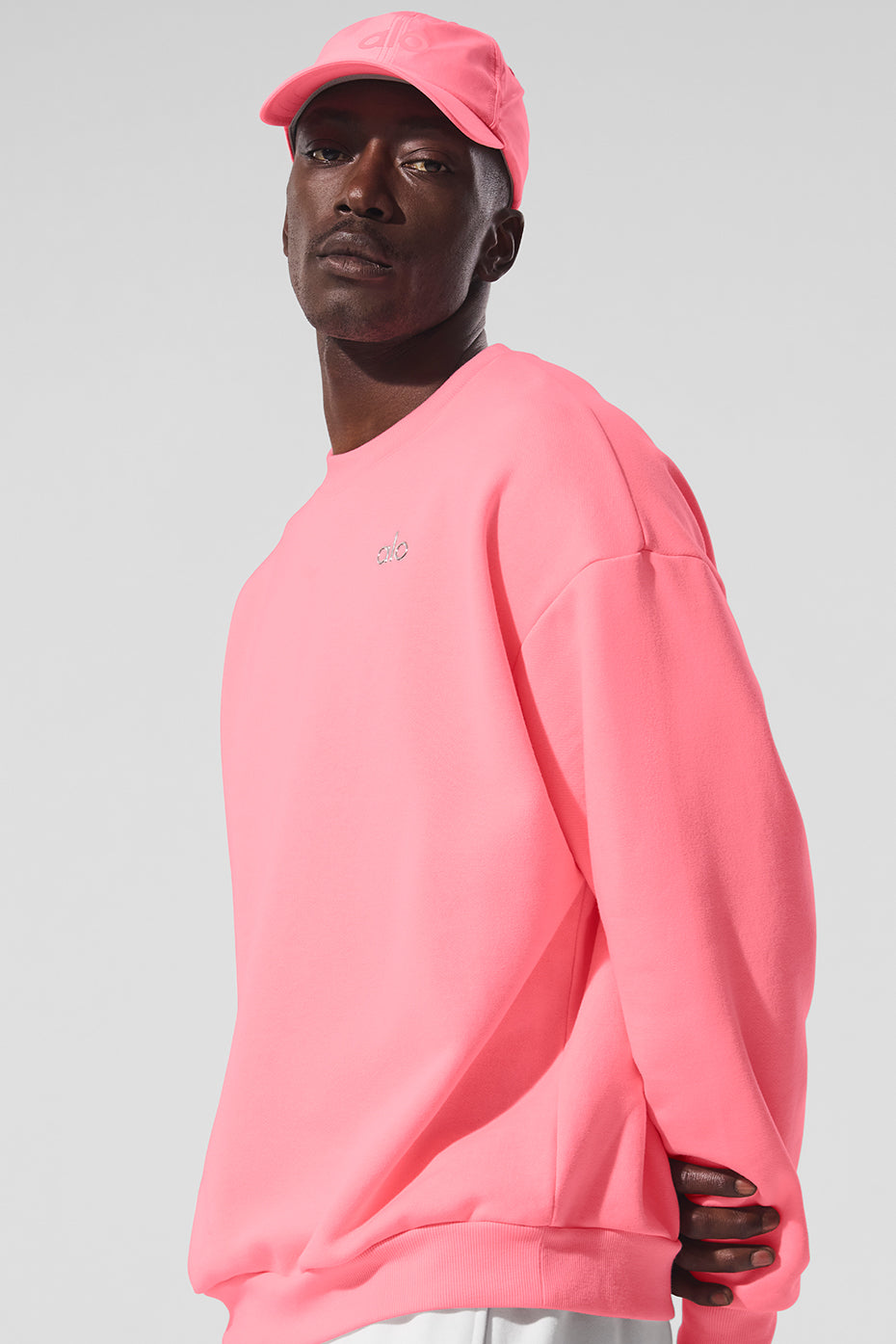 Close-up of ribbed cuffs and hem on the vibrant neon crew neck pullover
