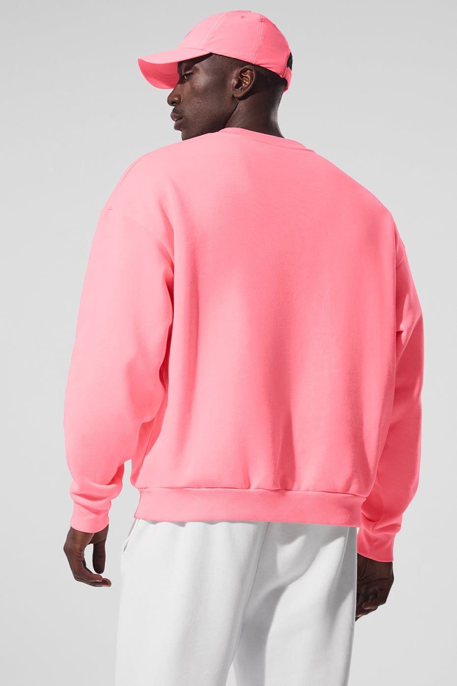 Model wearing the French terry pullover with relaxed fit and dropped shoulders in casual street setting
