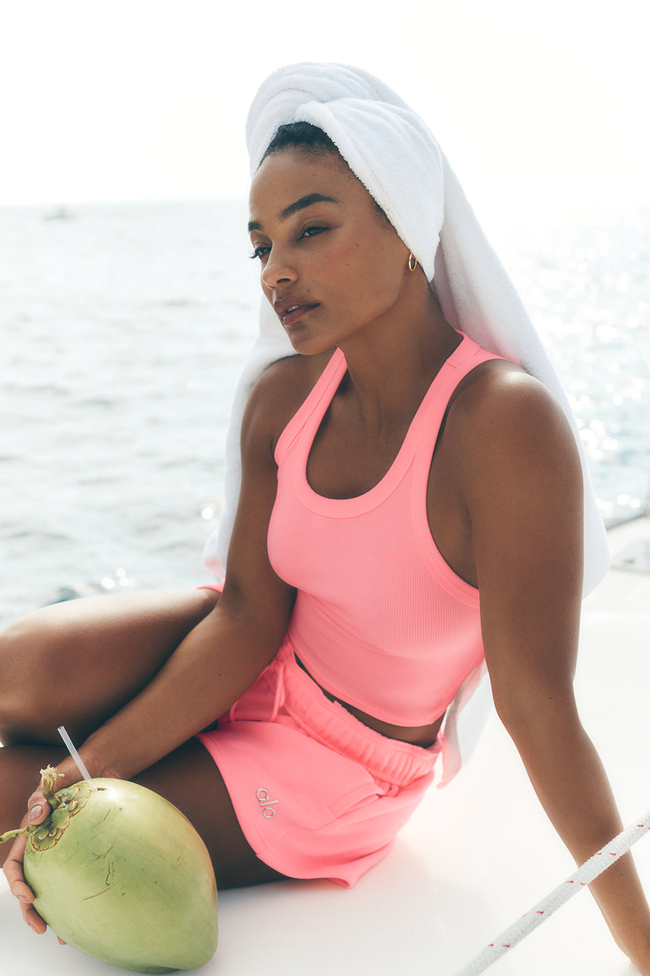 Front view of the neon bubblegum ribbed tank top on a model, highlighting its fit and color