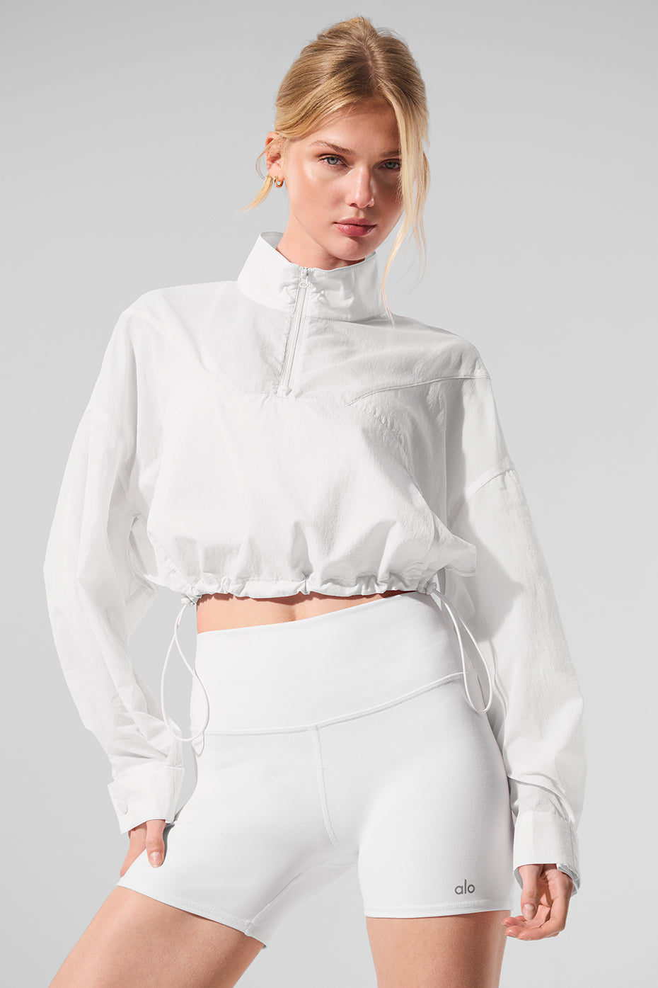 Front view of the white cropped pullover, showcasing its stylish design.
