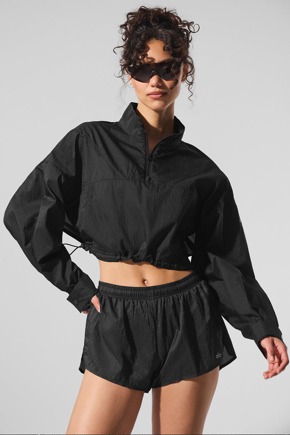 Side view of black cropped pullover styled for outdoor errands