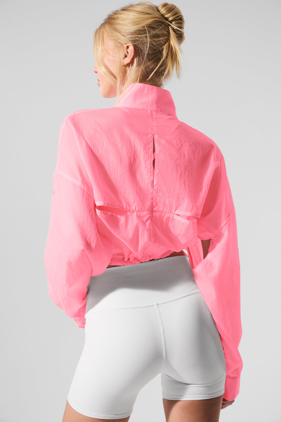 Model wearing the white cropped pullover during a workout session.