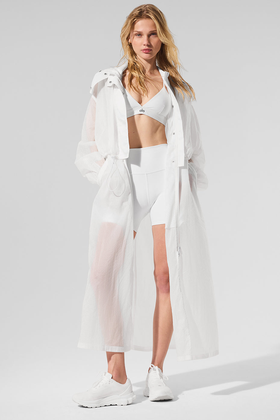 White trench coat womens style worn open with jeans and boots