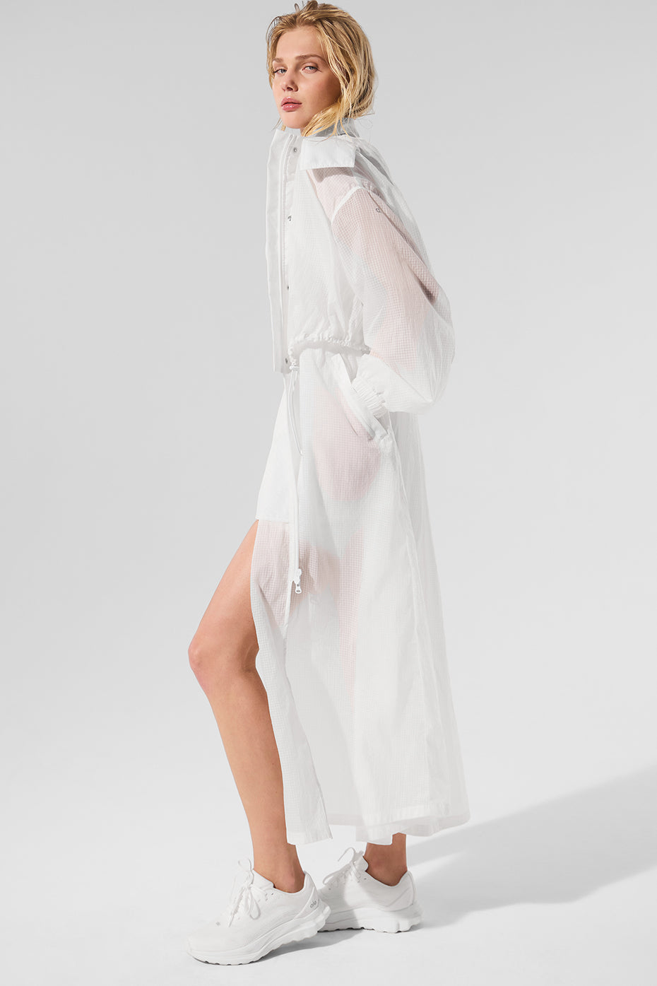 White trench coat womens style worn open with jeans and boots