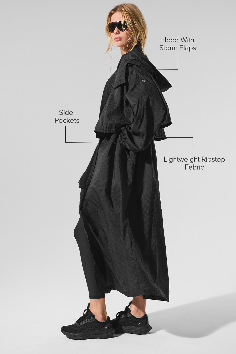 Side angle showing cinched waist and storm flaps of trench&coat design