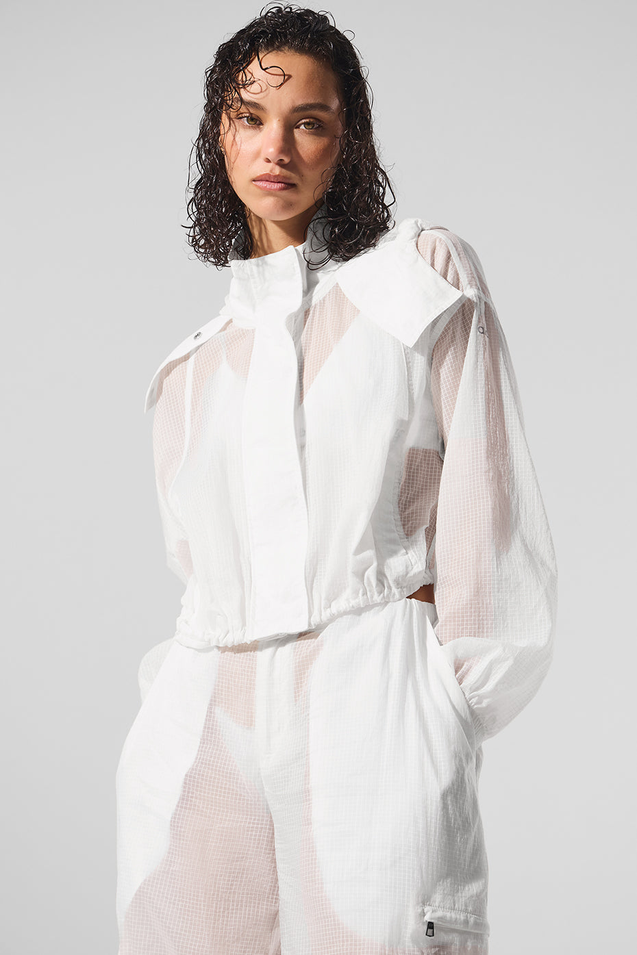 Model tying up the breathable cropped jacket after workout