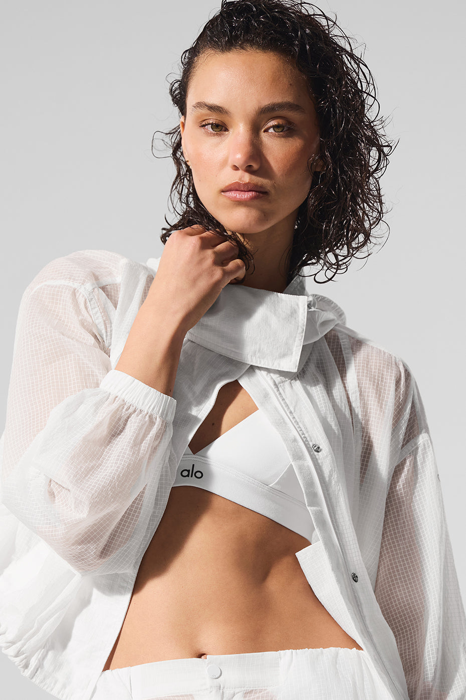 Front view of white cropped full zip jacket with sporty look