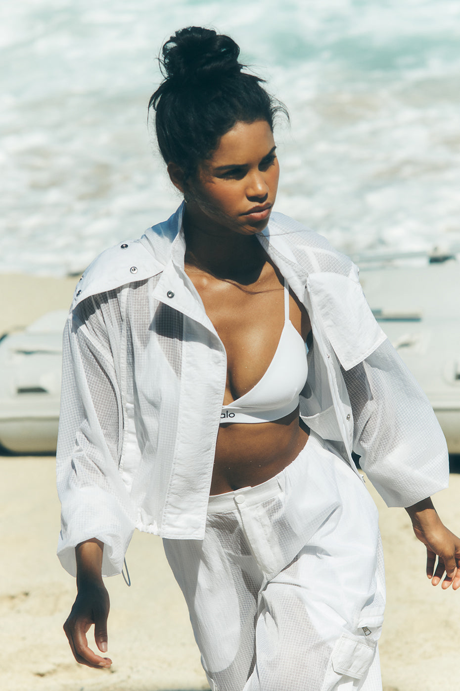 Front view of white cropped full zip jacket with sporty look