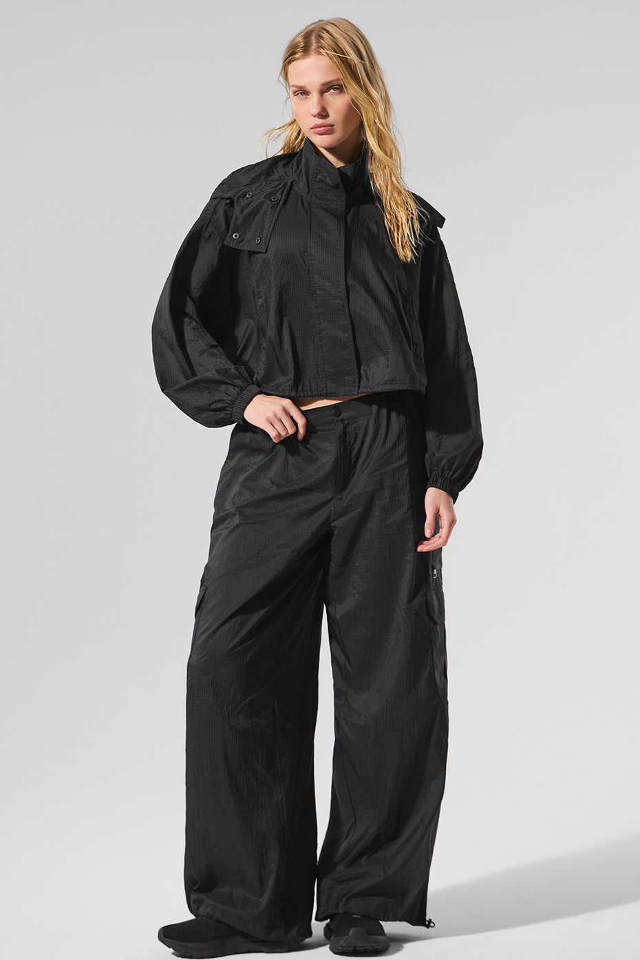 Model wearing the cropped zip jacket after a workout, highlighting its breathable fabric.
