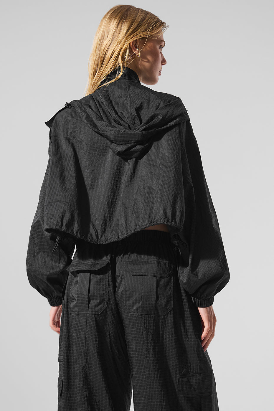 Close-up of the cropped zip up jackets details, emphasizing its quality and fit.