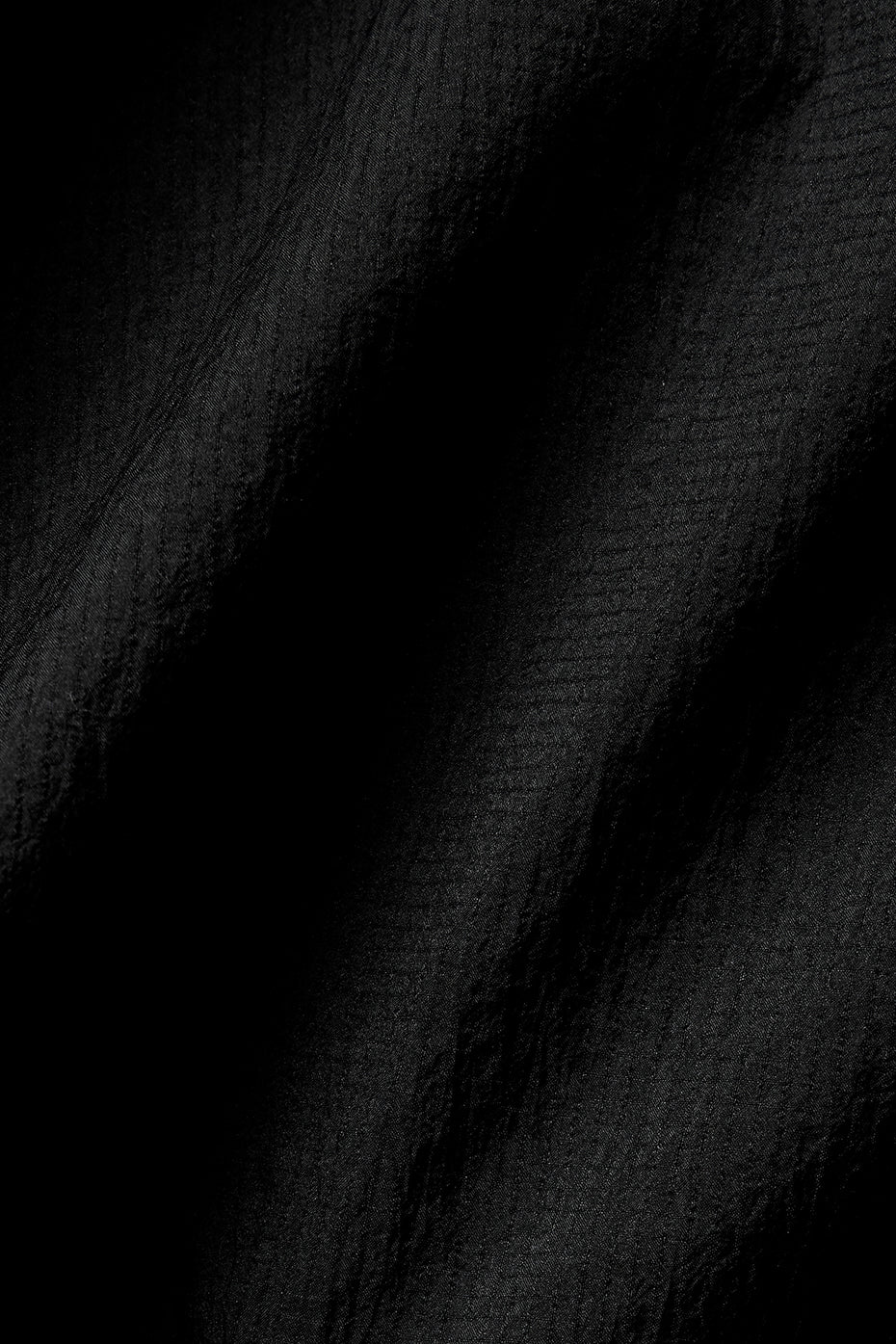 Close-up of the cropped zip up jackets details, emphasizing its quality and fit.