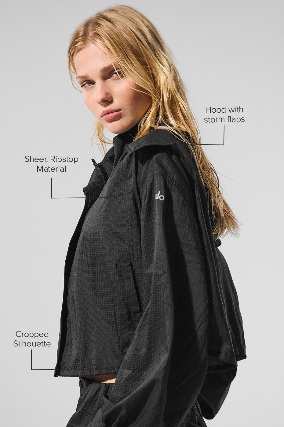 Model wearing the cropped zip jacket after a workout, highlighting its breathable fabric.