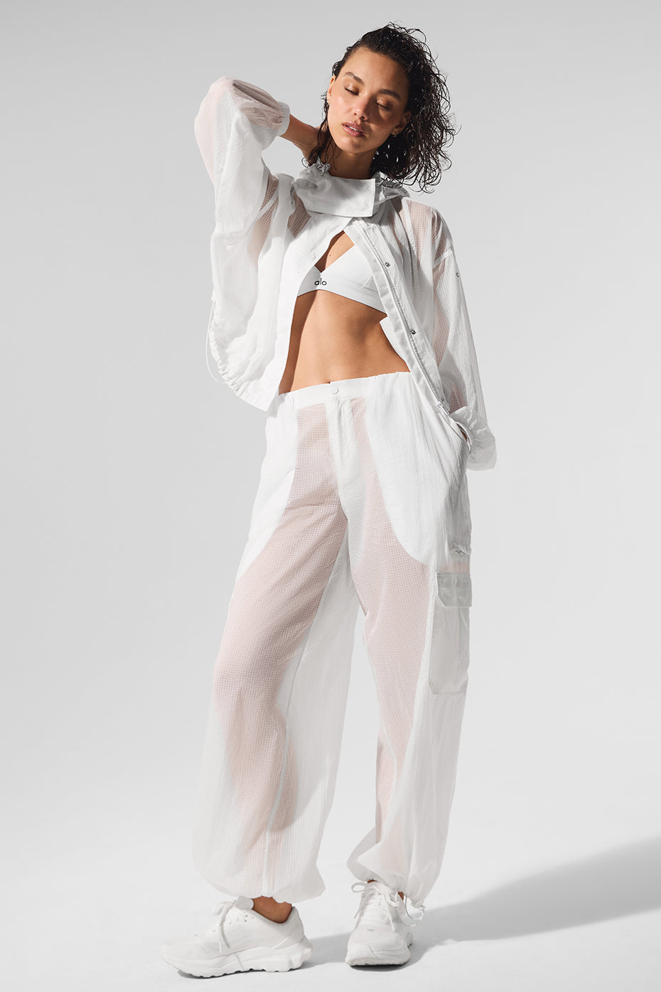 Model wearing white wide leg joggers with a casual crop top outdoors