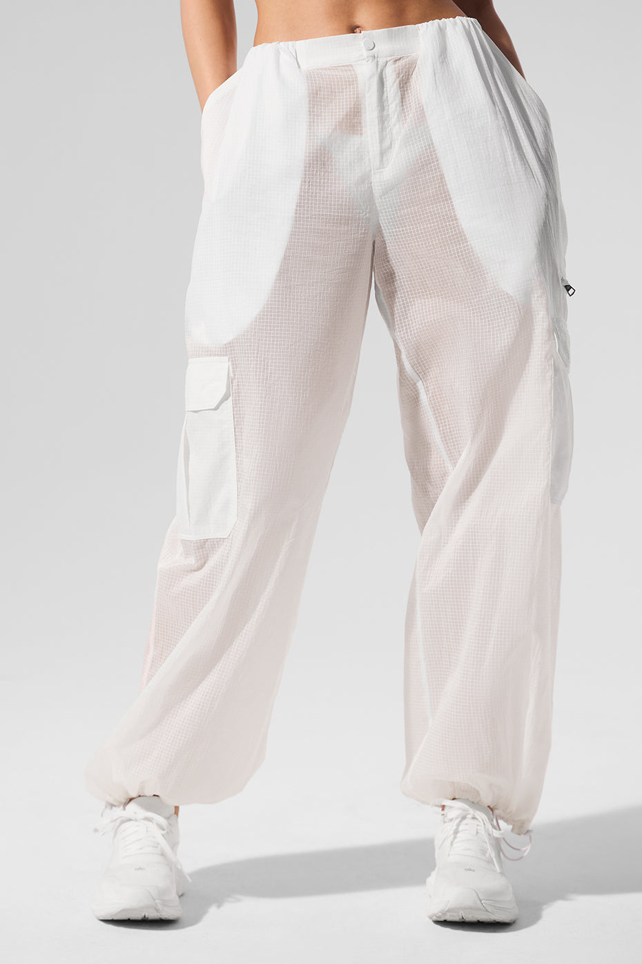 Close-up of lightweight fabric and oversized cargo pockets on wide leg joggers