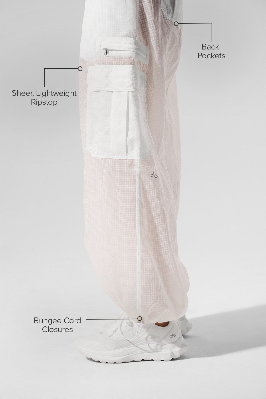 Model wearing white wide leg joggers with a casual crop top outdoors