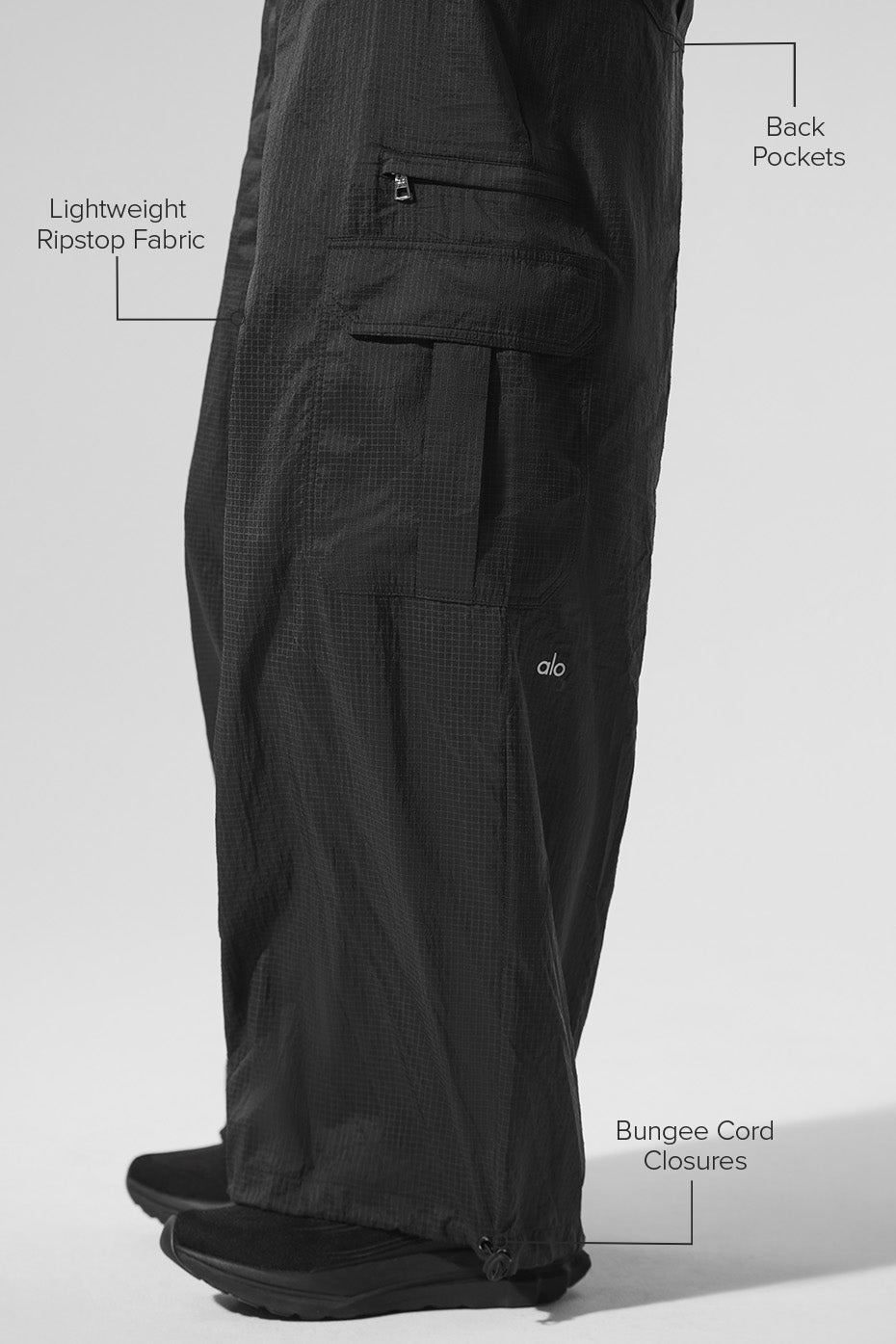 Side view of womens black joggers, highlighting the relaxed fit.