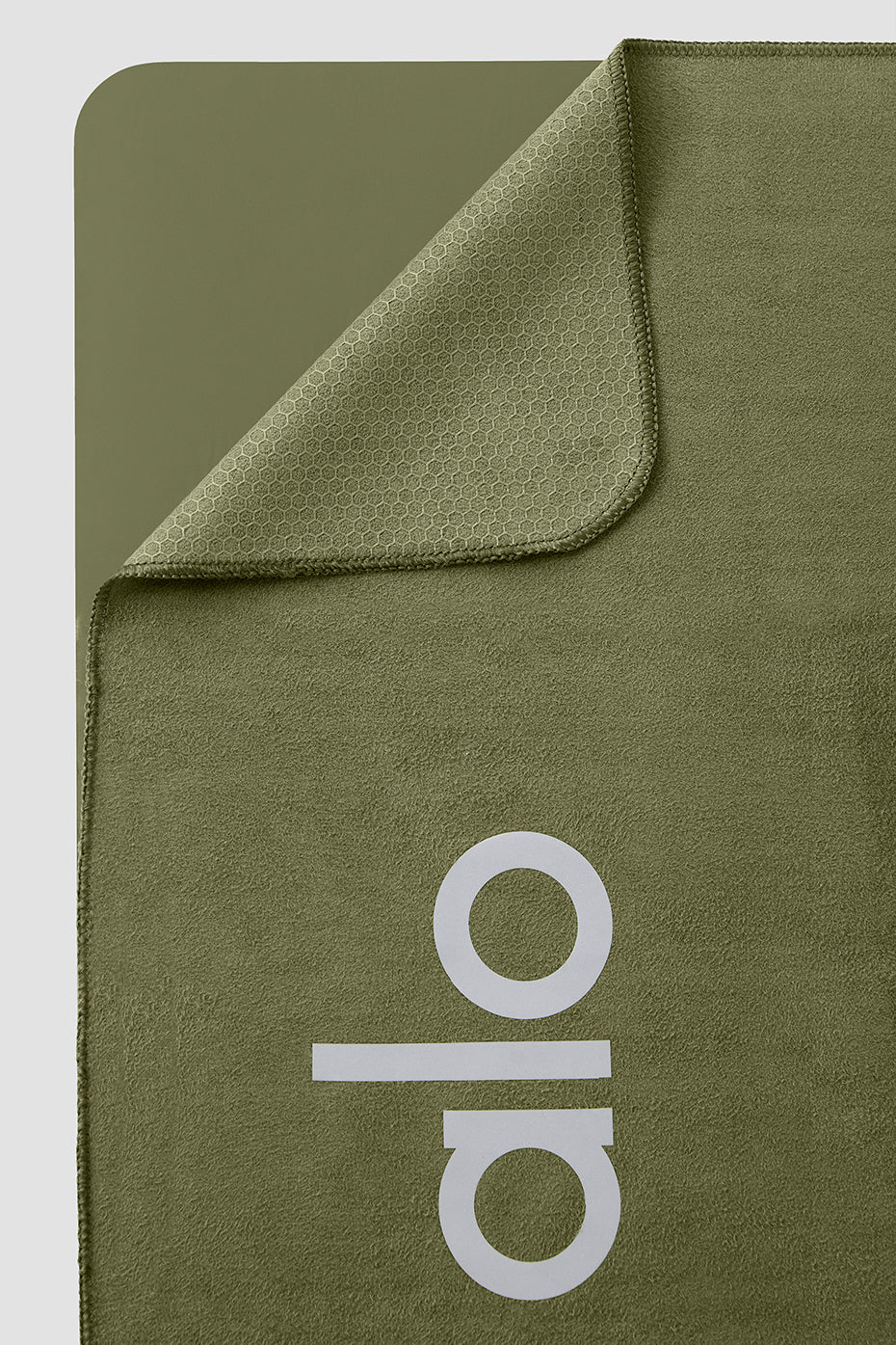 Absorbent yoga towel featuring silicone grip backing for stability during sweaty workouts