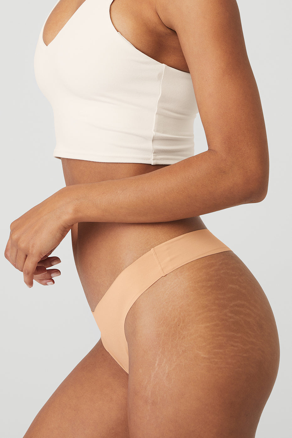 Model wearing the breathable underwear cotton thong under fitted leggings