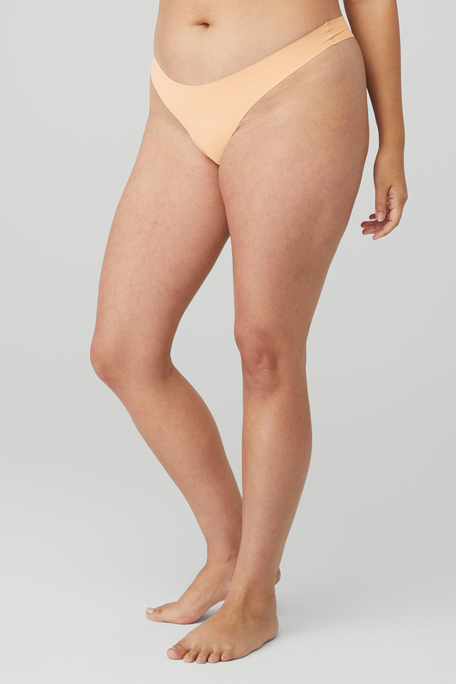 Model wearing the breathable underwear cotton thong under fitted leggings