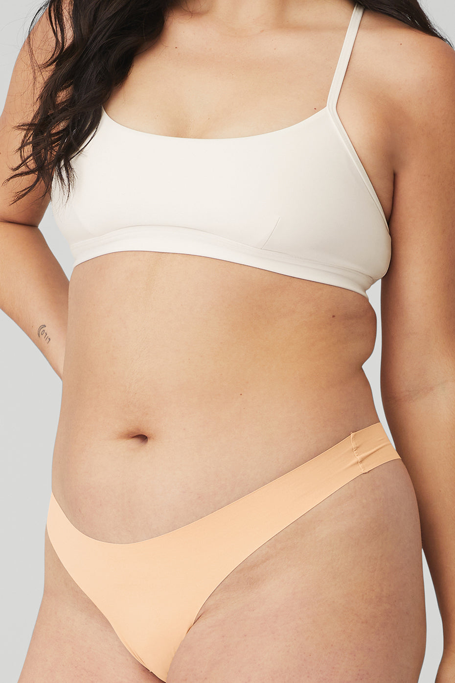 Close-up of raw-edge finish on invisible thong for seamless look