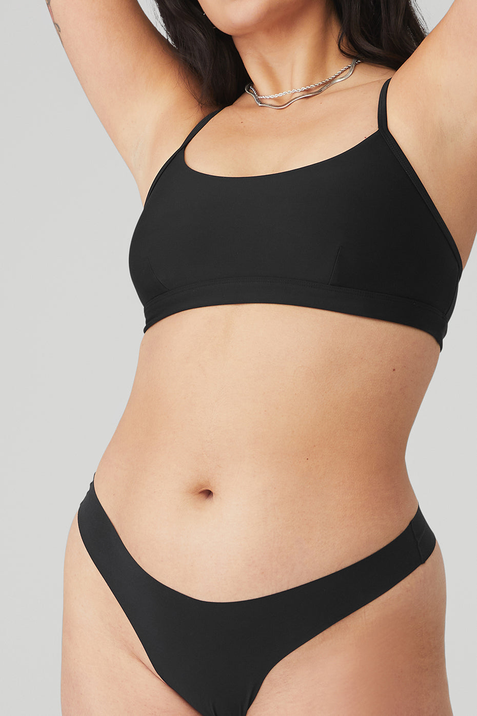 Model wearing the lightweight lingerie thong under fitted leggings