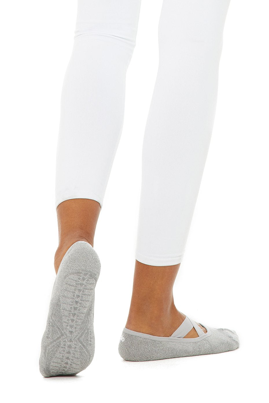 Dove grey barre socks in use during a studio workout.