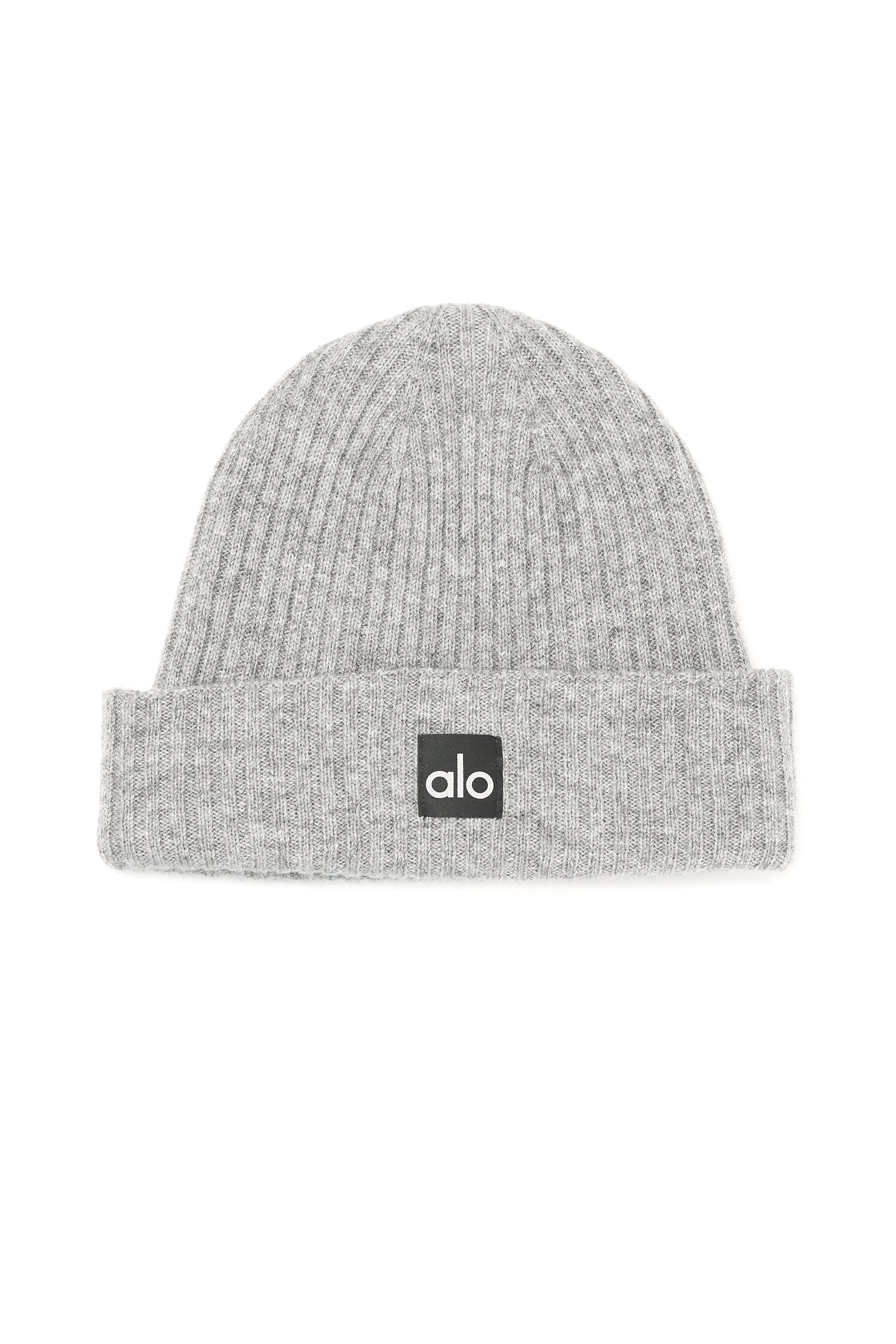 Dove grey cashmere beanie folded on a wooden surface