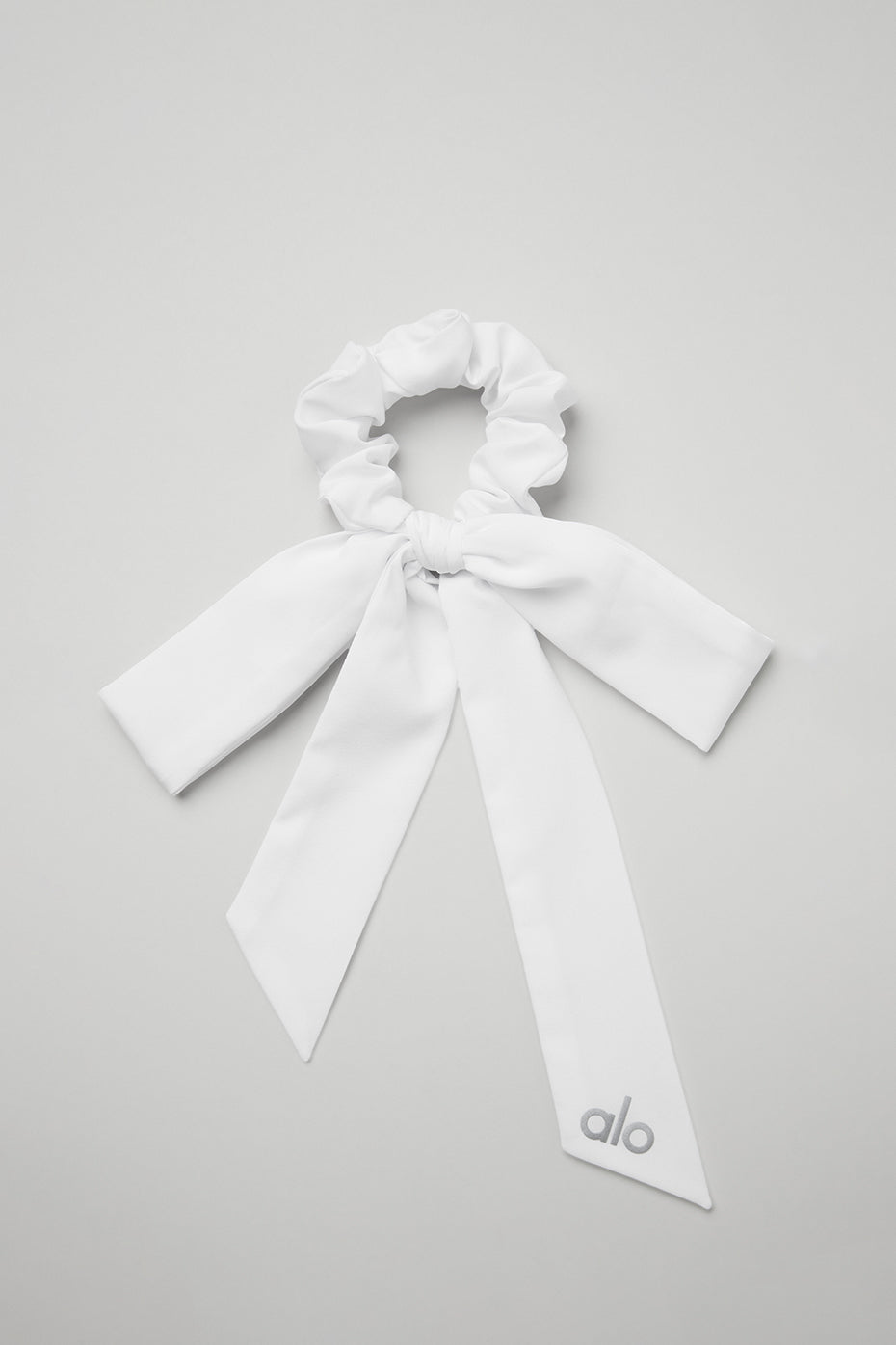 Close-up of the white tie scrunchie with bow detail.