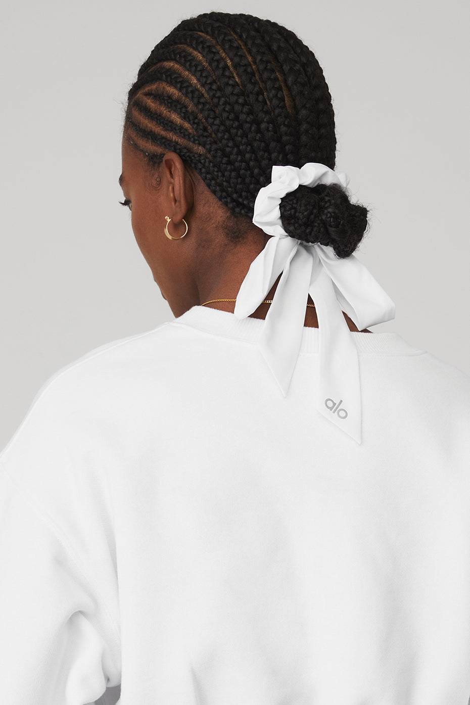 Model wearing the white scrunchie in a casual hairstyle.