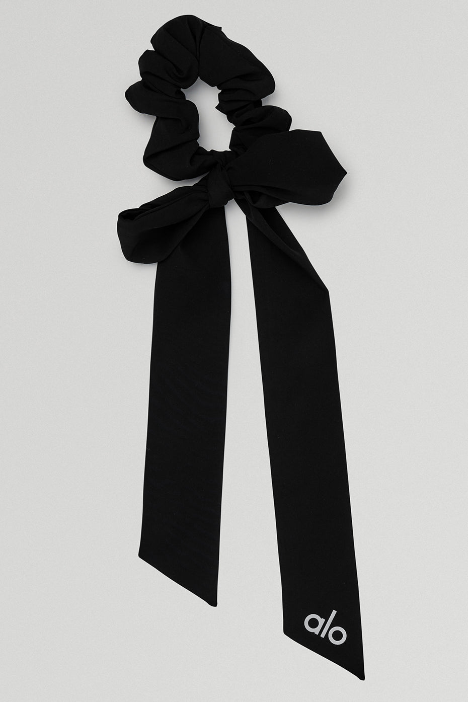 Close-up of chic black bow scrunchie showcasing its elegant design.