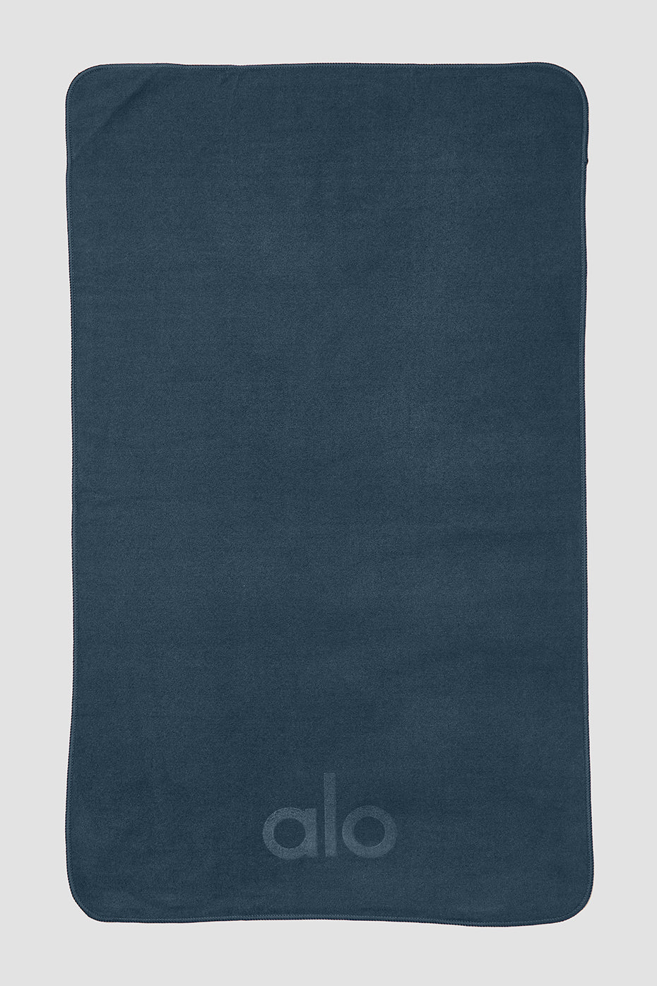 Close-up of the ultra-soft microfiber yoga towel on a yoga mat.