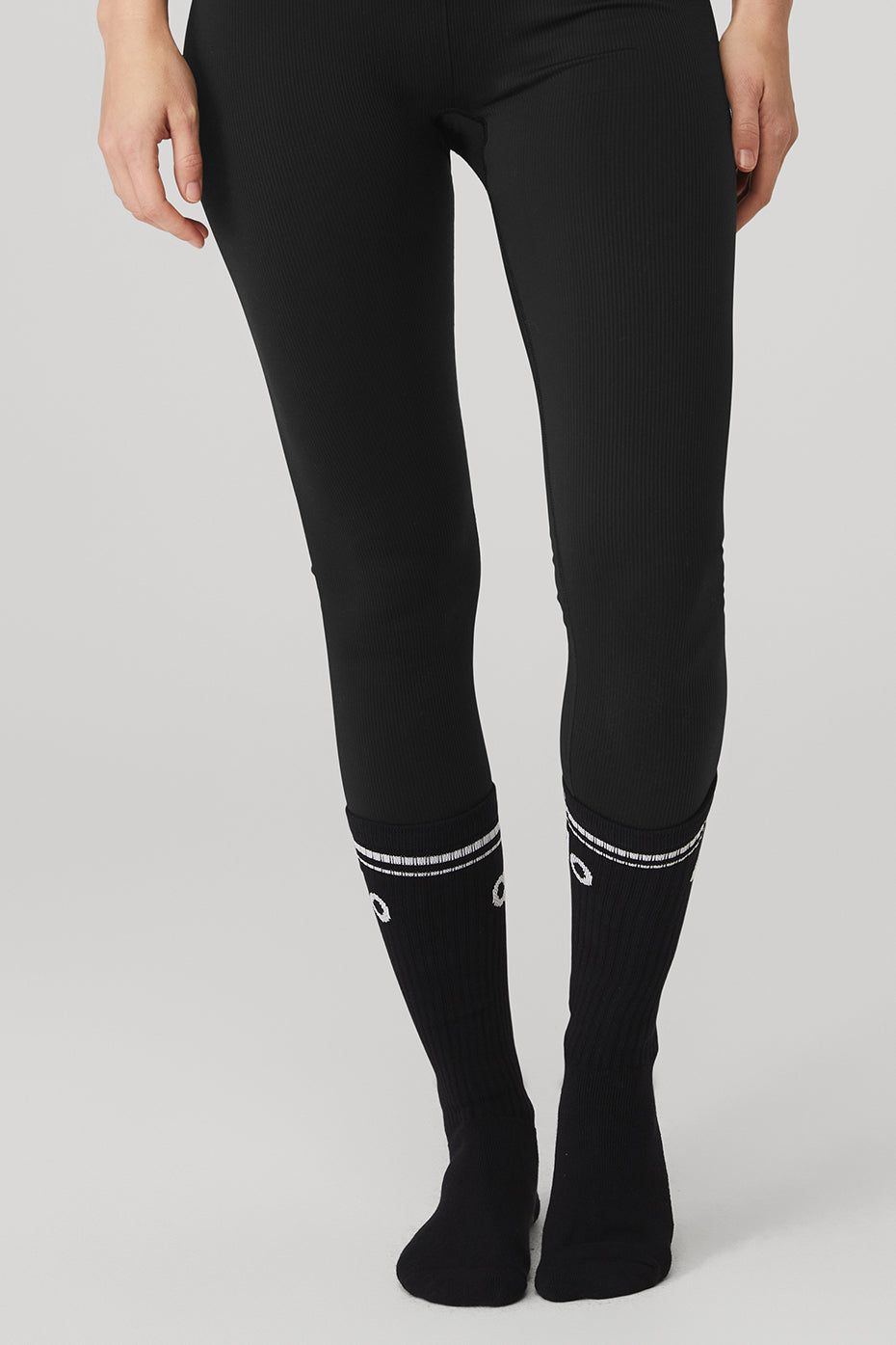 Woman demonstrating barre class wearing classic comfort barre socks.