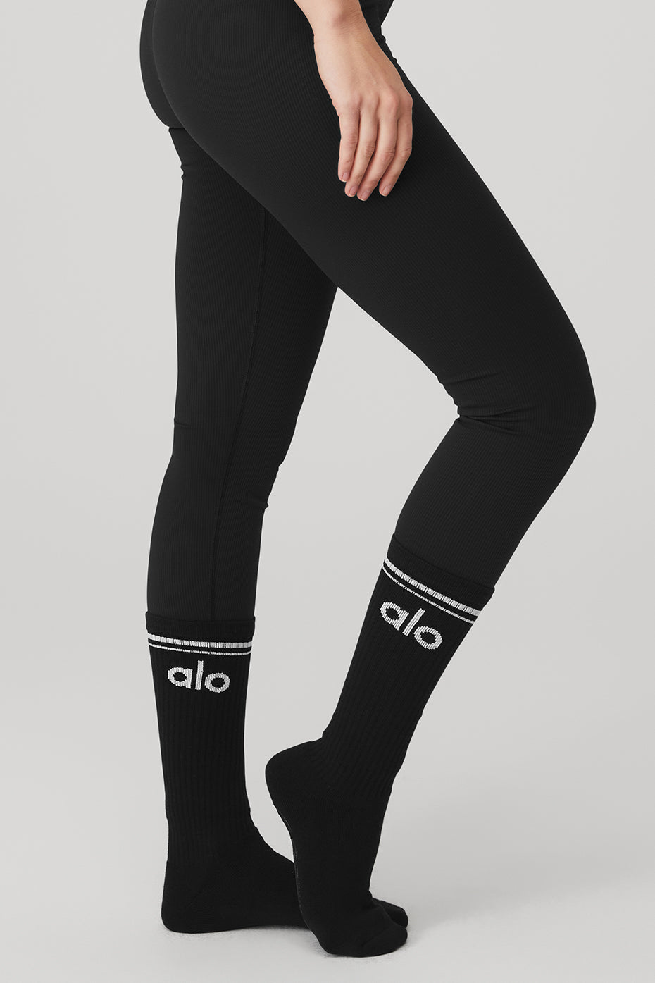 Stylish black and white barre socks laid flat, highlighting stripe design.