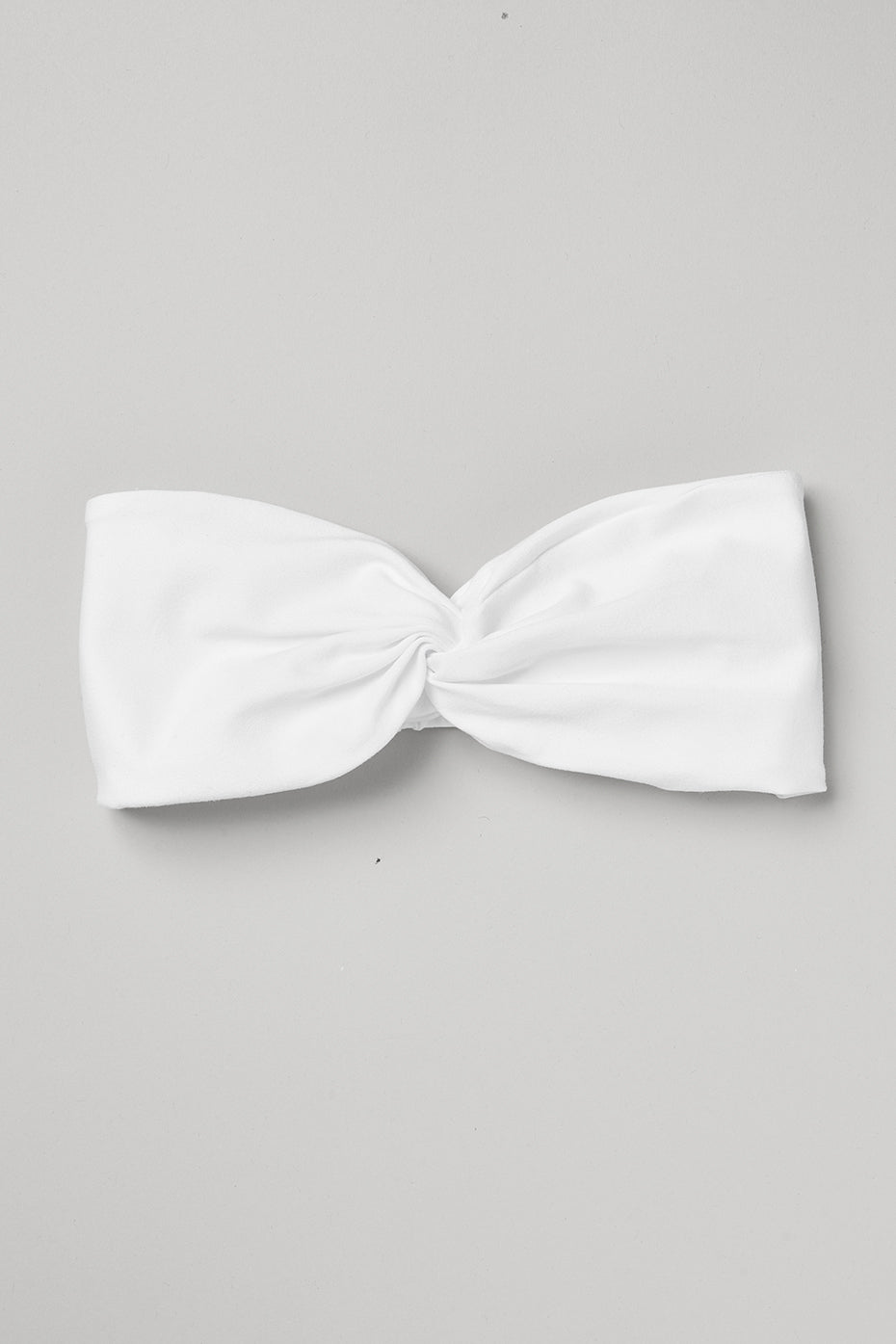 White Alosoft headband with cinched detail, perfect for yoga and running