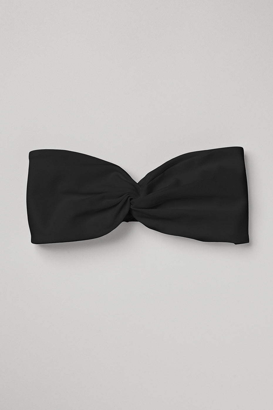 Front view of the black sueded headband worn during yoga practice.