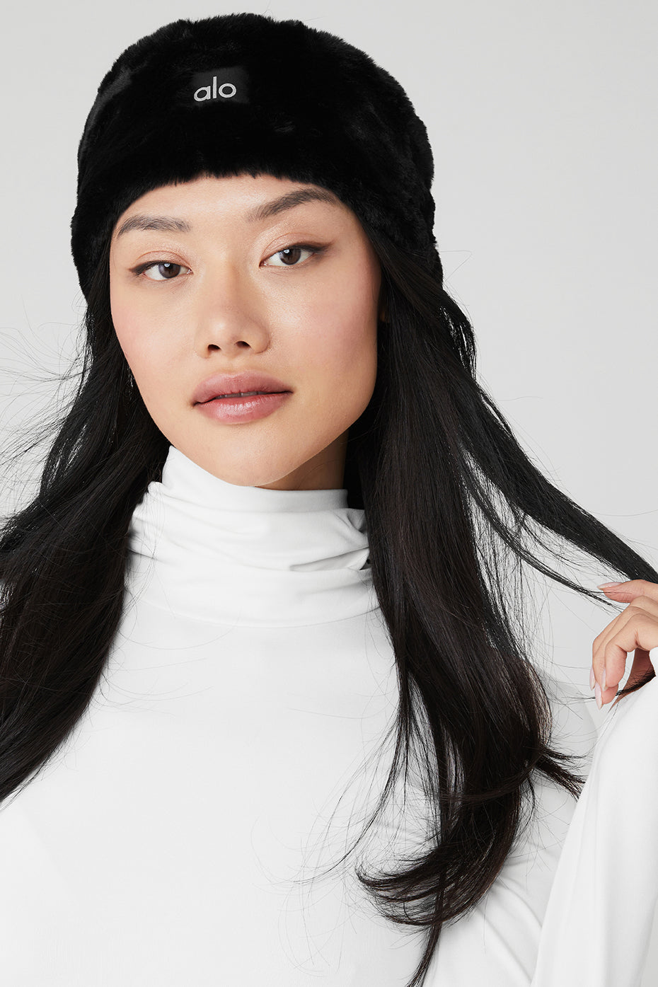 Close-up of black faux fur ear warmers showing soft texture