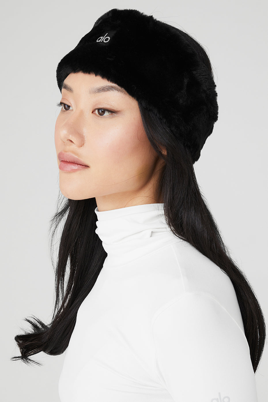 Close-up of black faux fur ear warmers showing soft texture