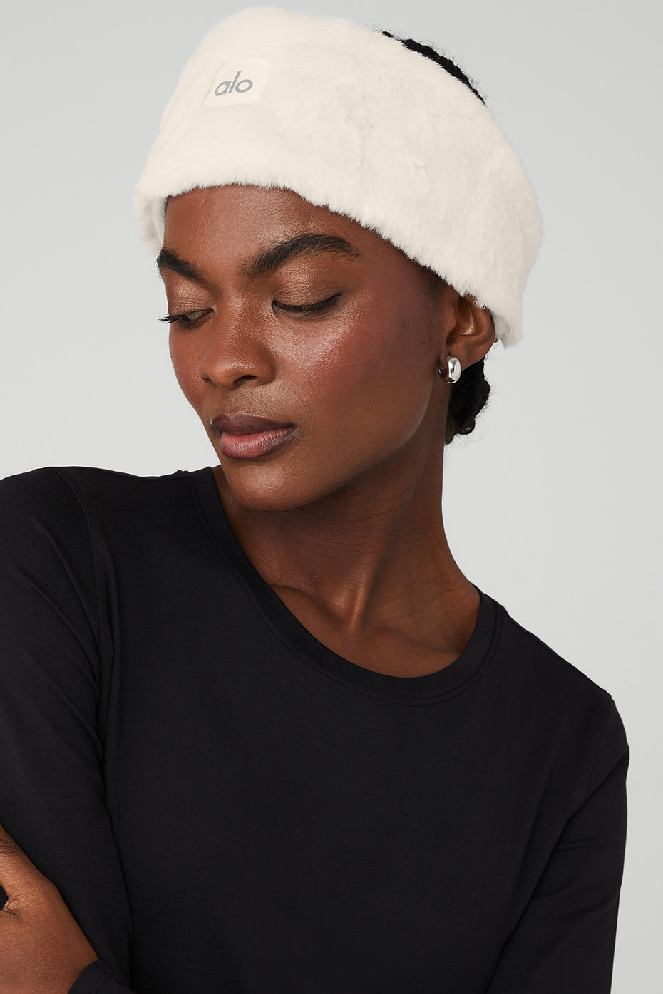 Ivory faux fur ear warmers on a woman's head for winter accessories