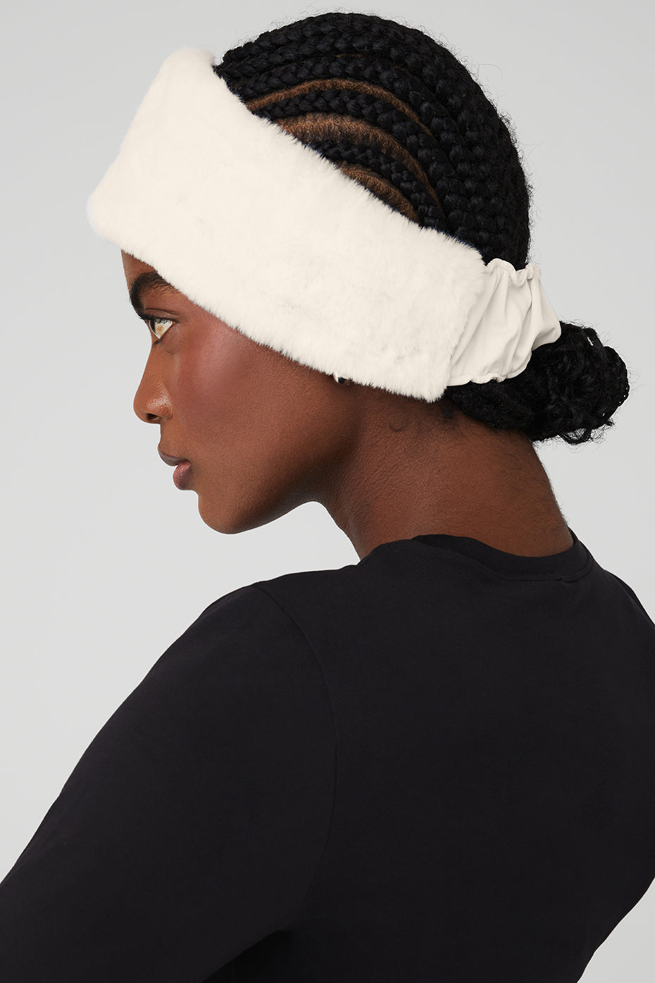 Ivory faux fur ear warmers on a womans head for winter accessories