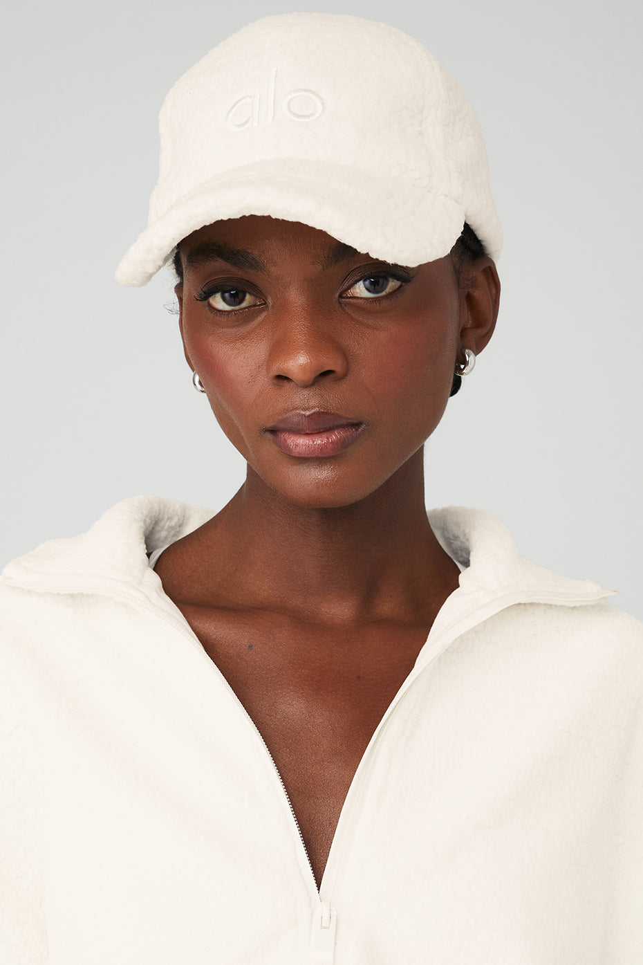 Front view of ivory sherpa dad hat with embroidered logo.
