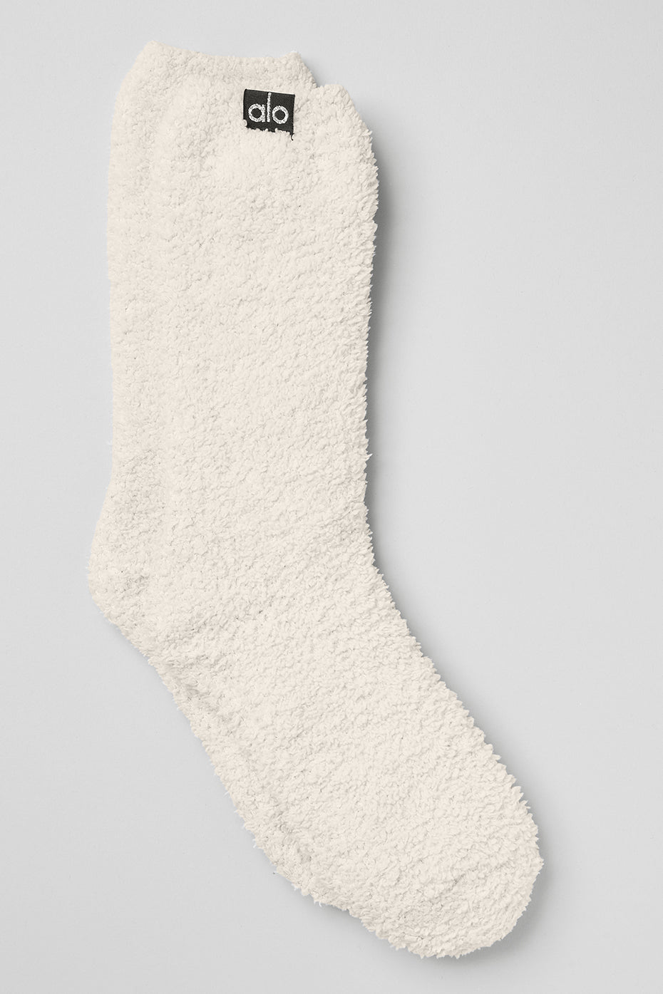 Close-up of plush ivory socks folded for lounge-ready use