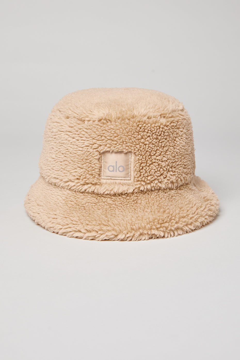 Close-up of the plush faux fur camel bucket hat showing texture.