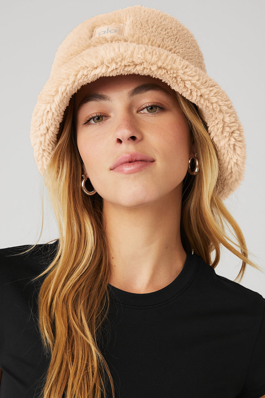 Stylish camel bucket hat displayed against a winter backdrop.