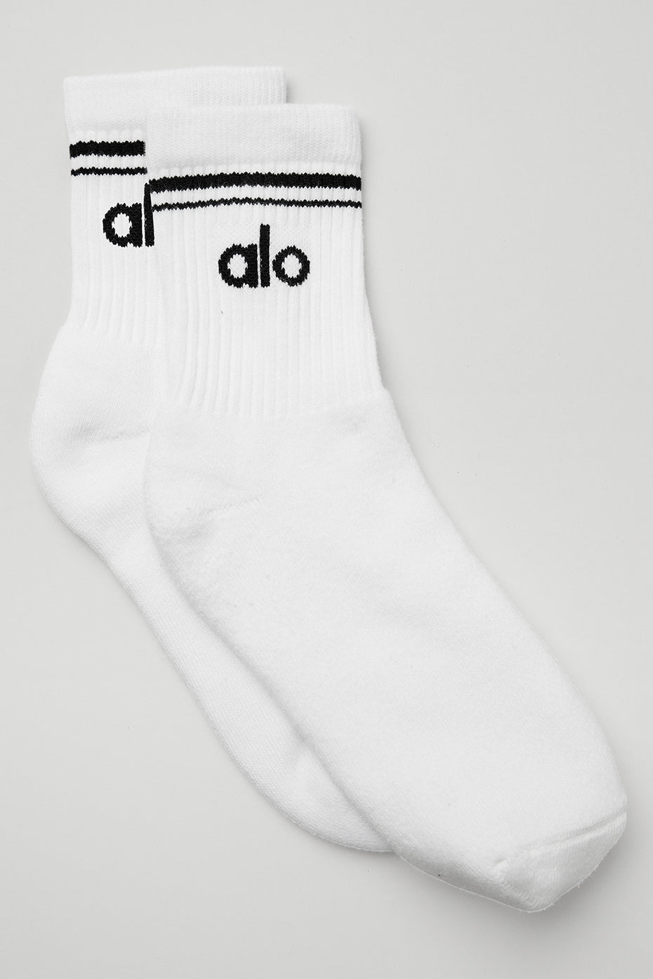 Close-up of retro crew socks in white and black, showcasing the stripe design.