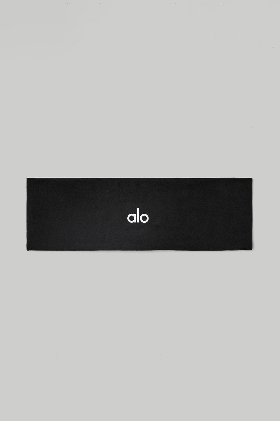 Close-up of the Ultimate Performance Headband in black, showcasing its moisture-wicking fabric.