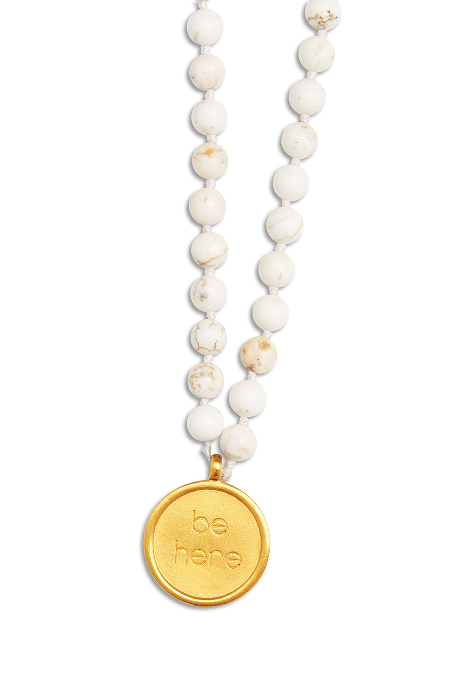 Close-up of white turquoise prayer beads mala necklace with gold pendant for meditation