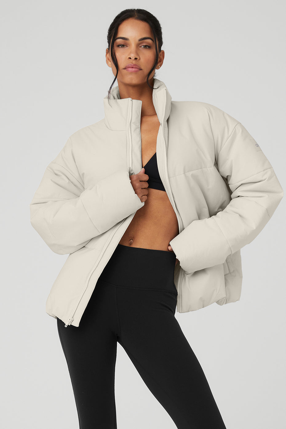 Model wearing the bone puffer jacket with a layered look for urban style.